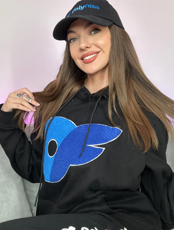Natalkan wearing a black sweater with a bold OnlyFans logo on it