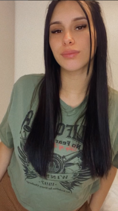 Vanessa Cherry dressed in a sexy green top and brown pants